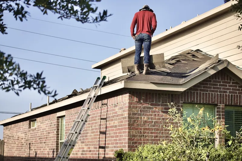 Professional roofer working on a residential roof in Skinnerville